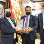 Handing a sponsorship shield to Al-Balqa Applied University